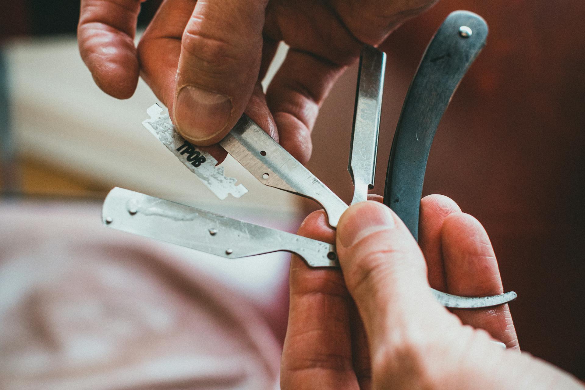 Hands holding vintage Solingen razor